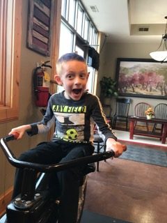 A child on the stationary bike in the salon's waiting area