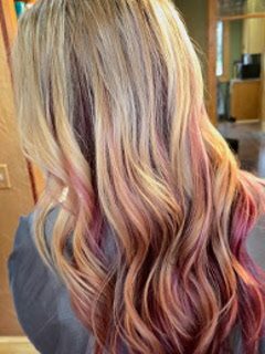 Long wavy hair coloured in blonde, pink and purple pastels