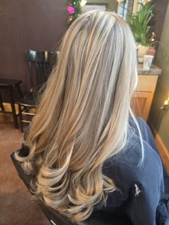 Long layered blonde highlights in soft curls