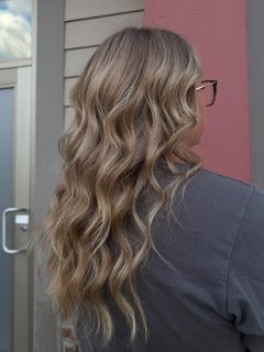 Shoulder-length layered bronde waves with glasses